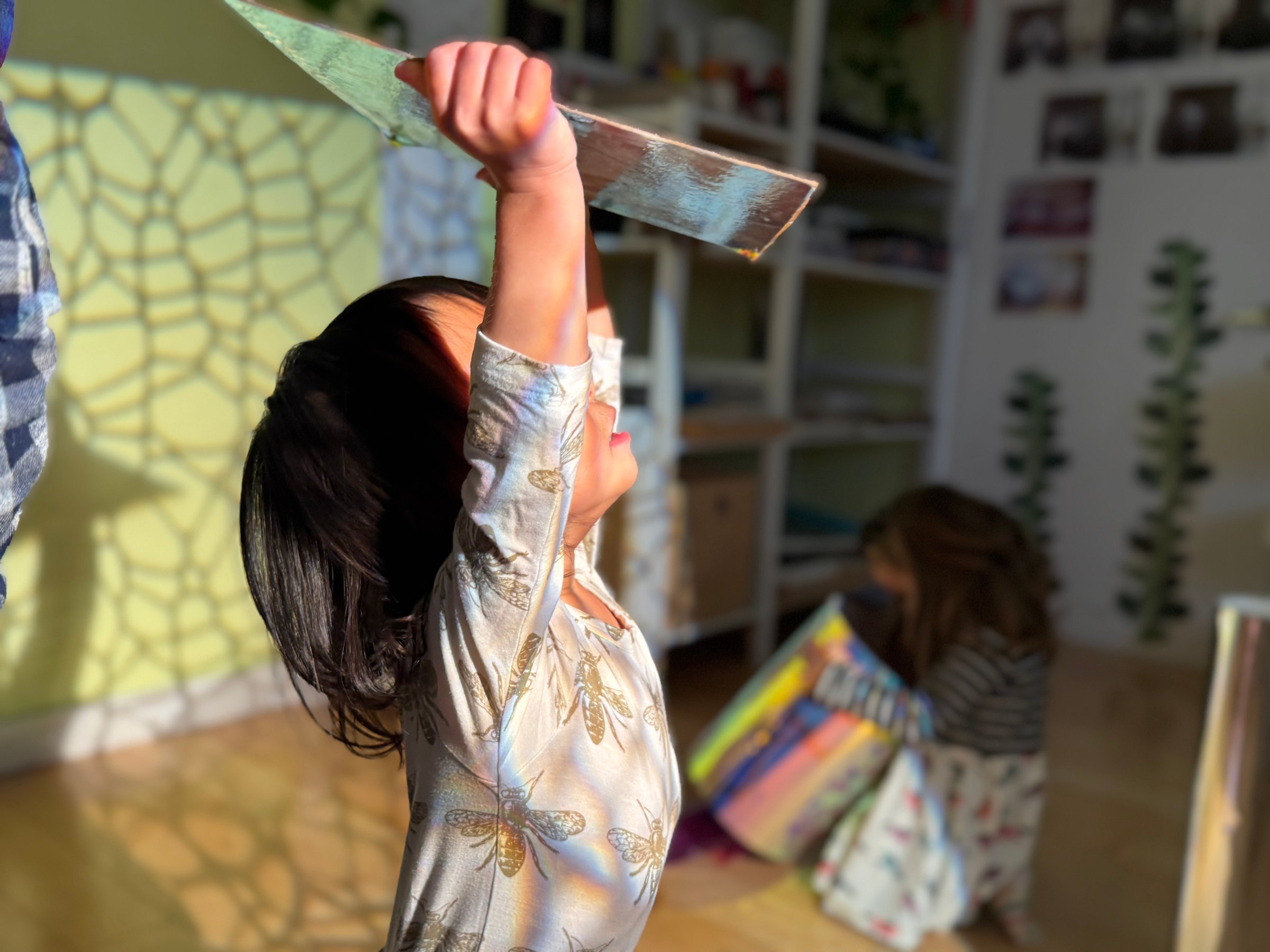Child holding a paintbrush
