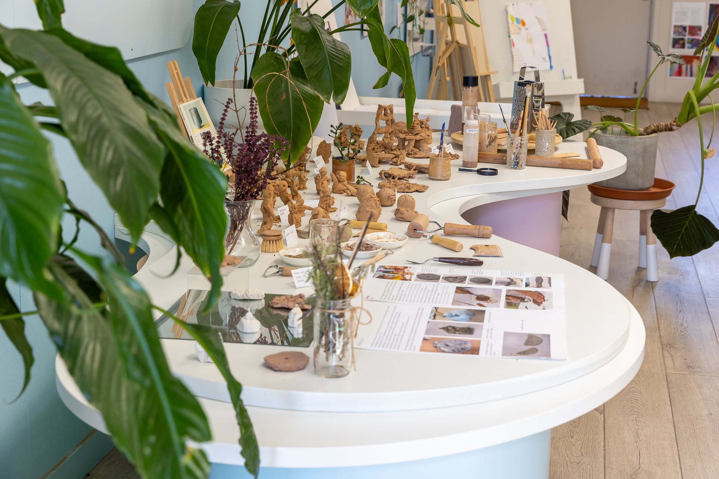 Clay figures and natural materials on a light table